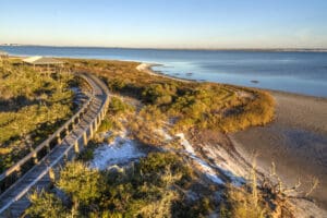 A,Boardwalk,Curves,Over,The,Vegetation,On,The,Dunes,In
