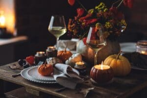 Fall,Composition.,Orange,Pumpkins,,Flowers,And,Candles,On,Wooden,Table.