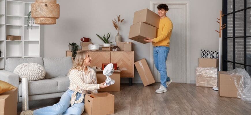 Young,Couple,Packing,Things,In,Room,On,Moving,Day